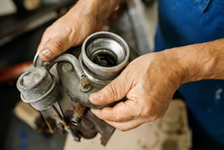 mechanic holding used toyota 3 Series F30 engine part